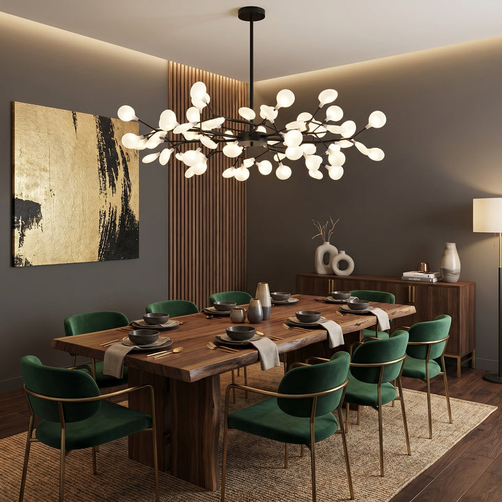 Schwarzer Kronleuchter über rustikalem Holztisch mit grünen Samtstühlen und goldenem Wandbild 3