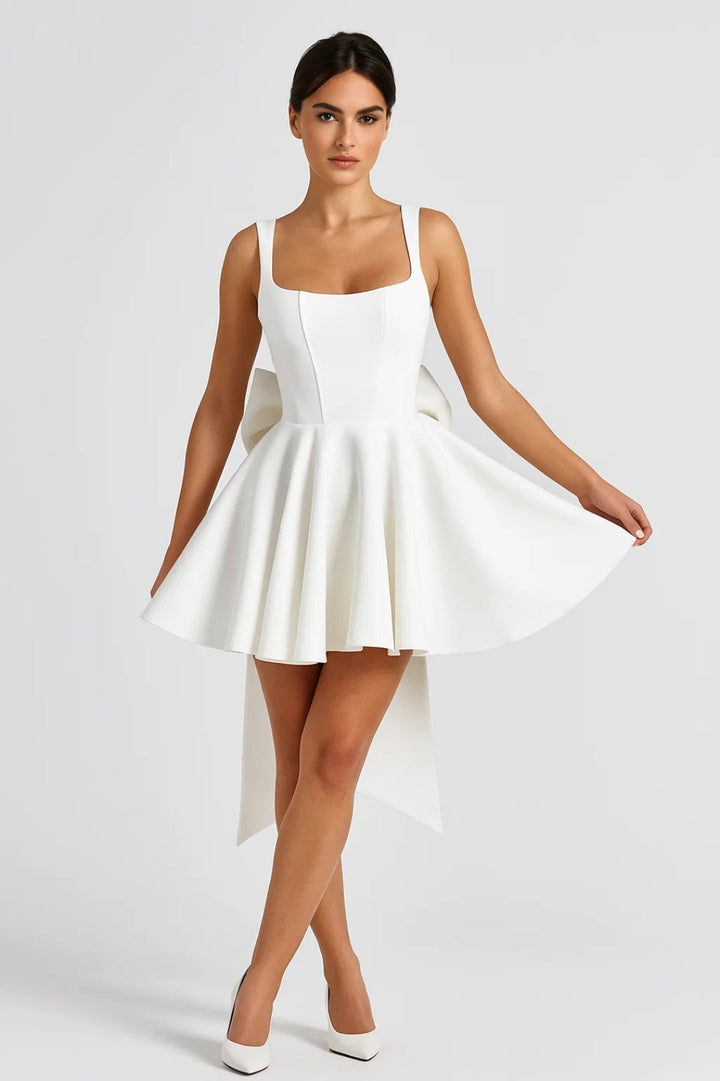 Model in weißem Minikleid von vorn, hält den schwingenden Rock mit einer Hand zur Seite 3