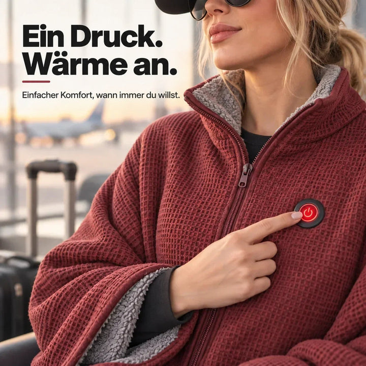Nahaufnahme: Finger drückt den roten Powerknopf der roten Decke, Reißverschluss und grauer Innenfleece sichtbar 9