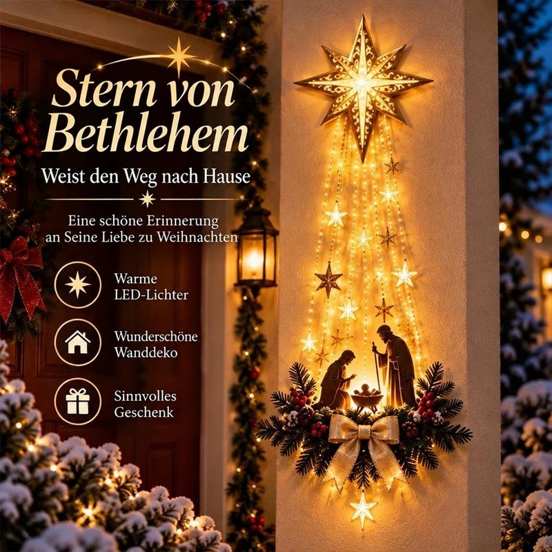 Leuchtender Stern mit Lichterkaskade und Krippenszene an einer Hauswand neben der Tür, abends mit Schnee 1
